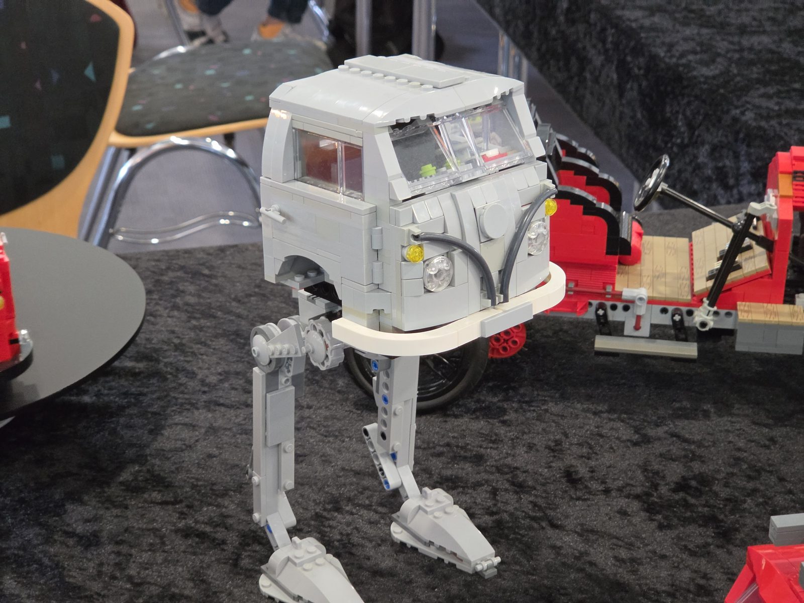 A LEGO VW T1 camper van standing on the legs of an AT-AT walker
